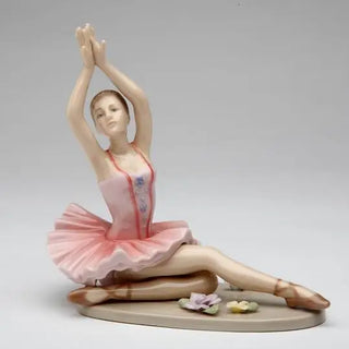 Porcelain Ballerina Posing in Pink Tutu Dress