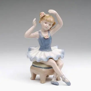 Porcelain Ballerina in Blue Dress Siting On Chair